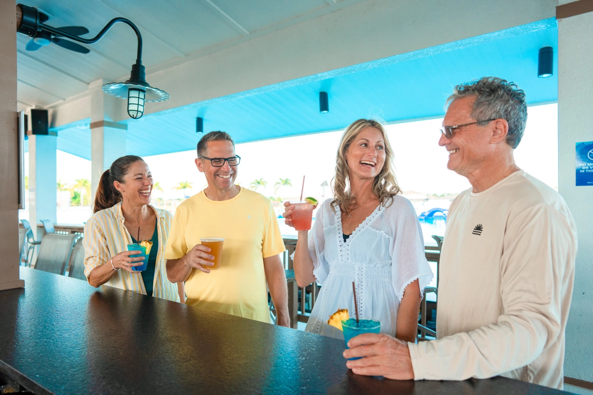 a group of people standing at a bar