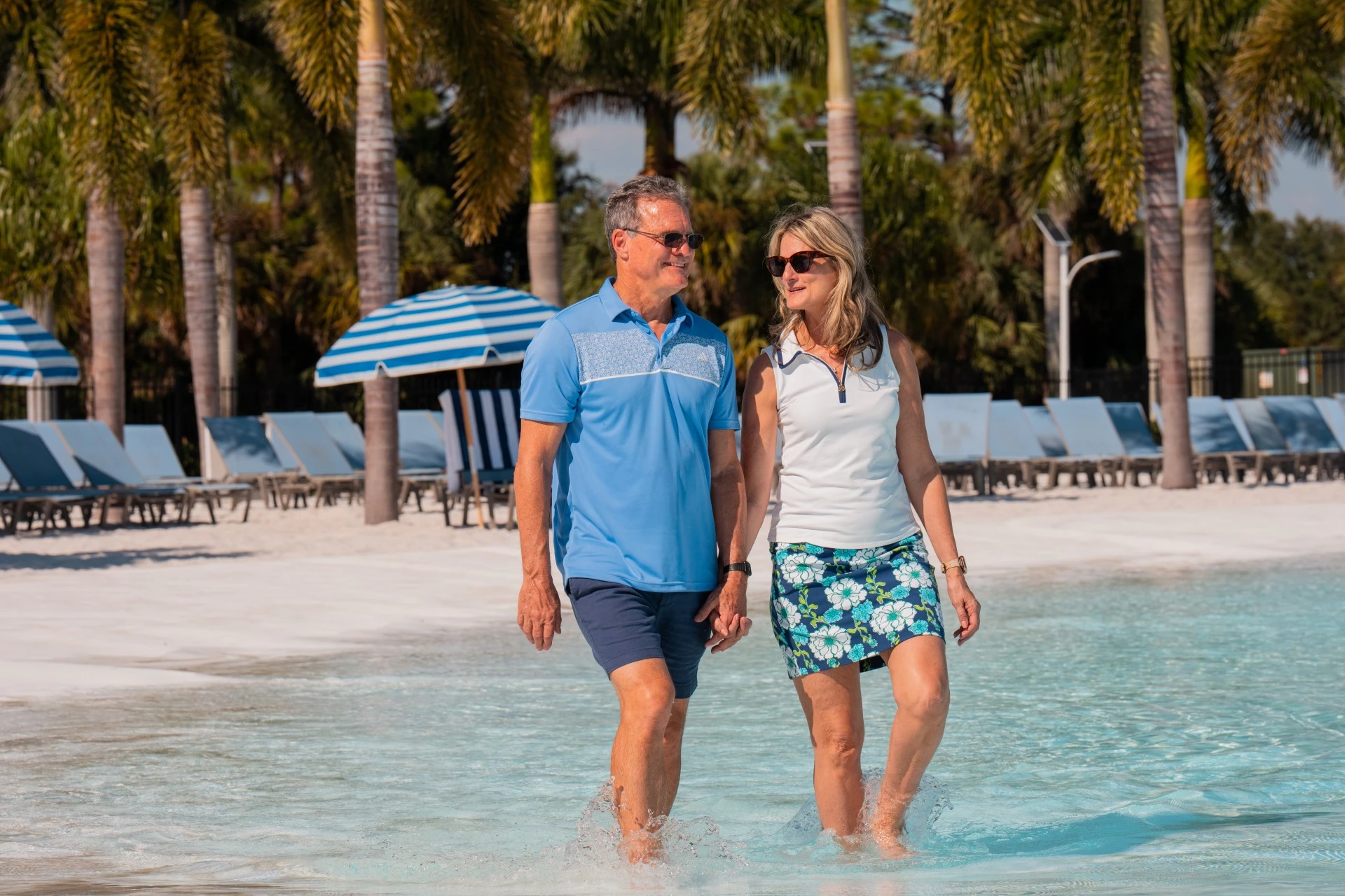 a man and woman walking in water