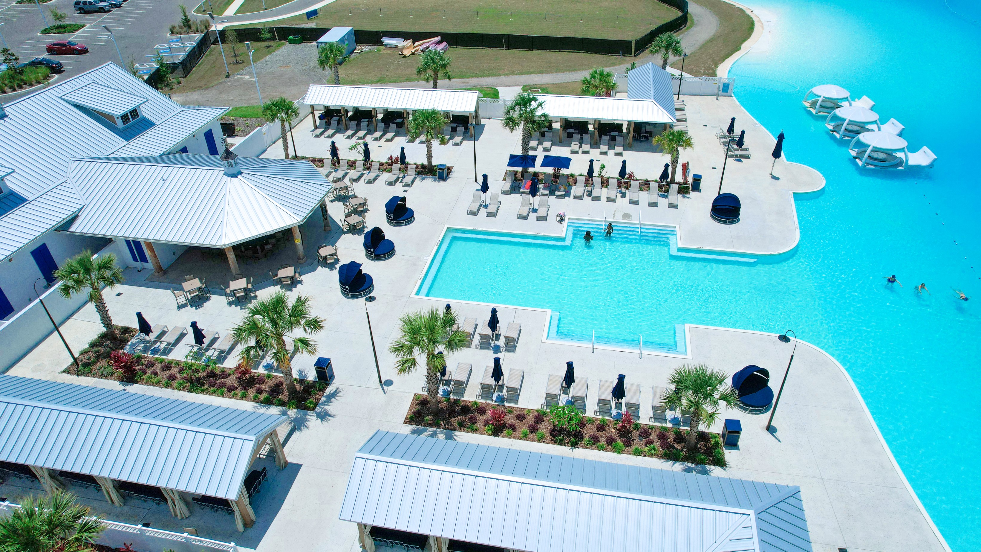 a pool and lounge chairs by a pool