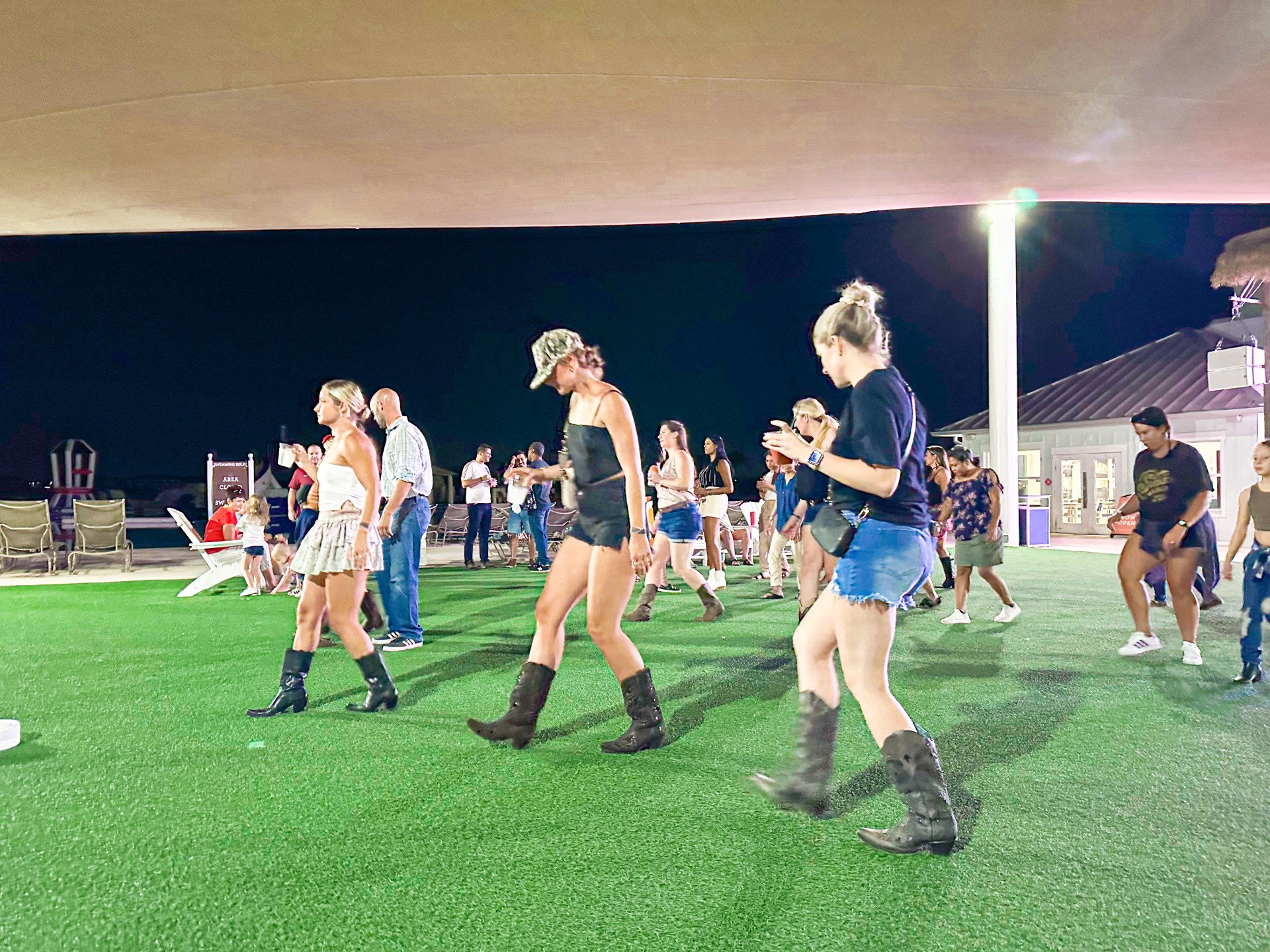 a group of women walking on a green field