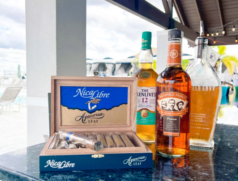 a group of bottles of alcohol and cigars on a table