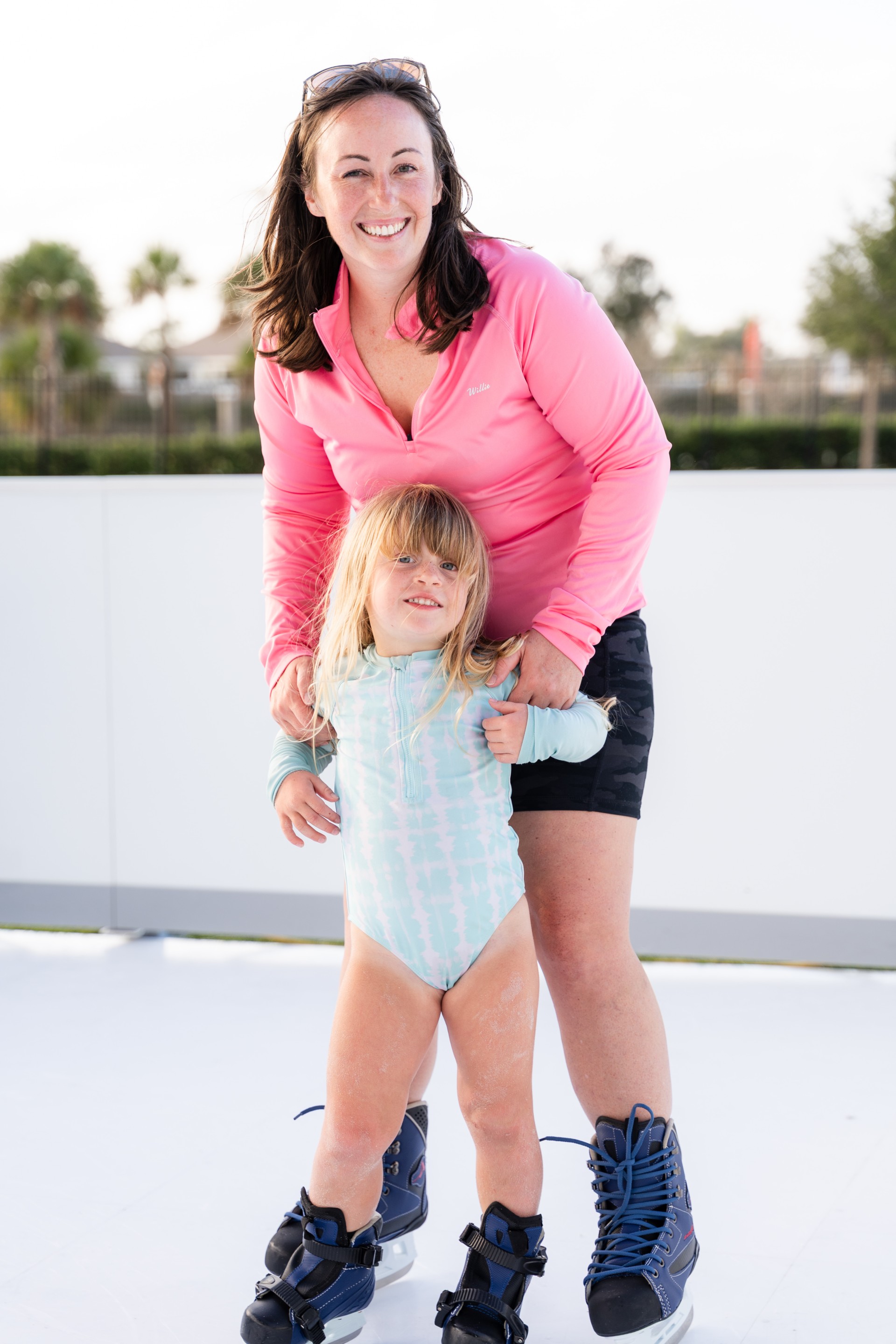 a woman and a child on ice skates