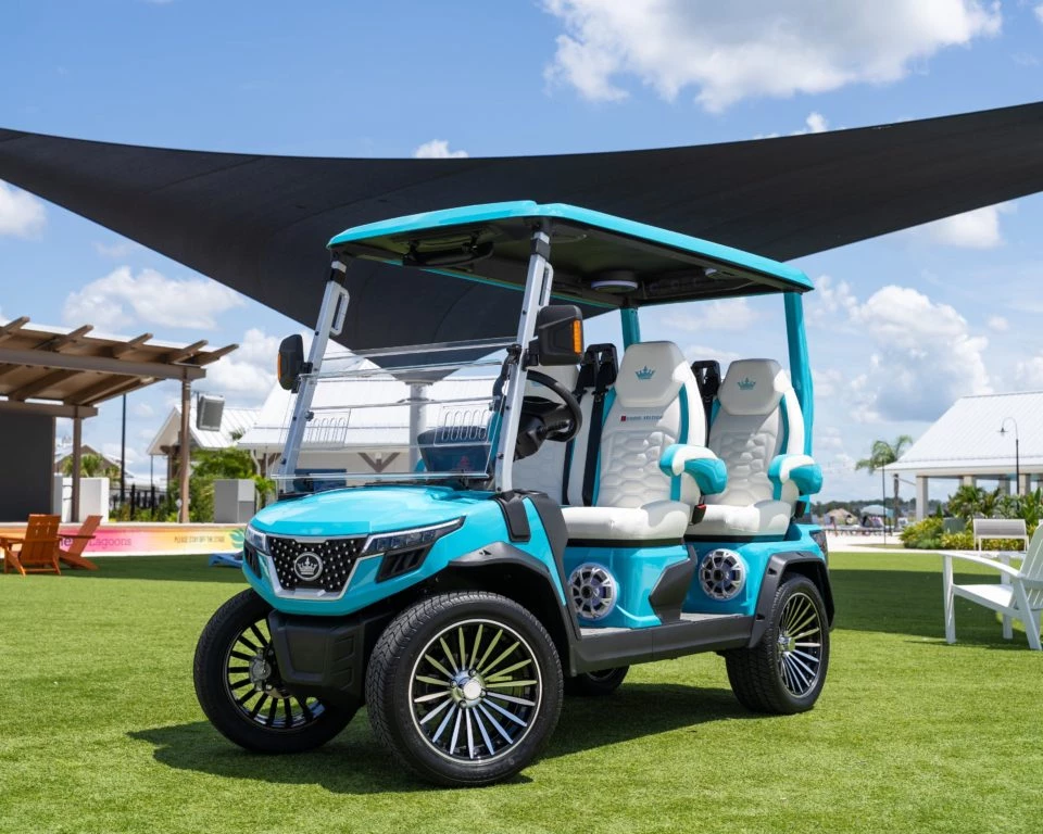 a blue and white golf cart on a green field