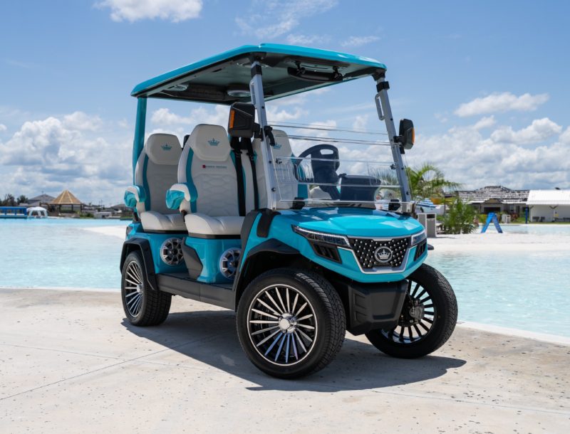 a blue golf cart parked by a pool