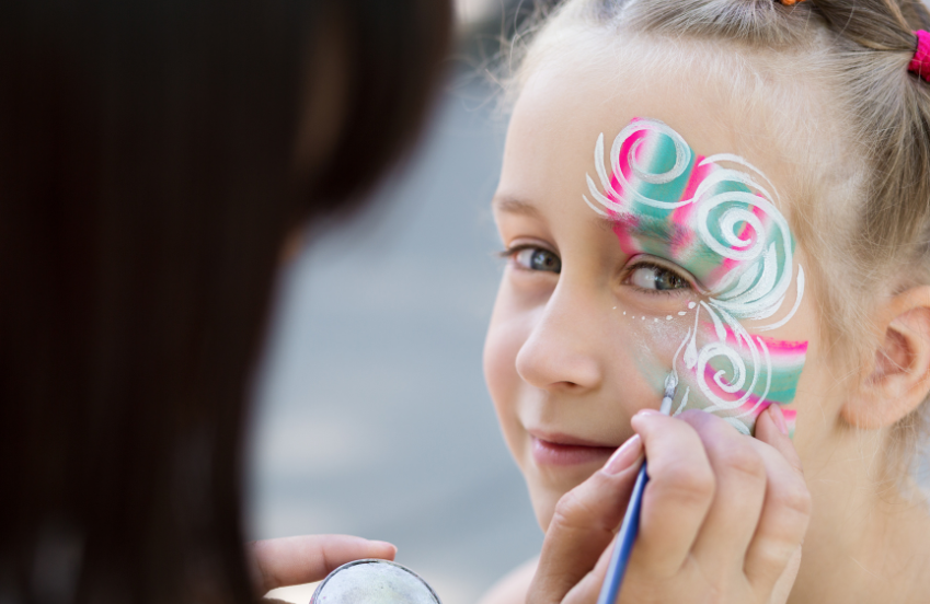 a girl getting her face painted