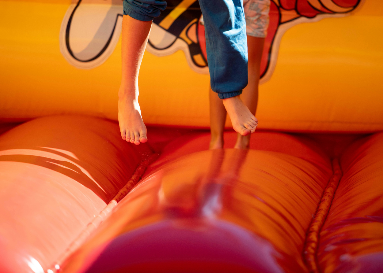 a person's feet on a bouncy castle