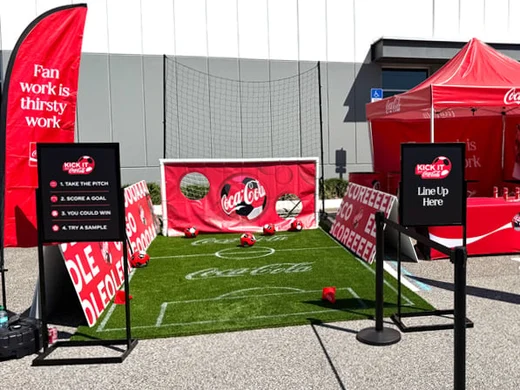 a football field with red banners and football balls