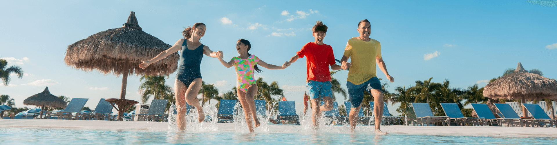 a group of kids running in water