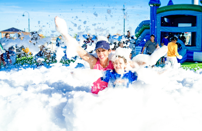 a woman and a boy in a foam ball