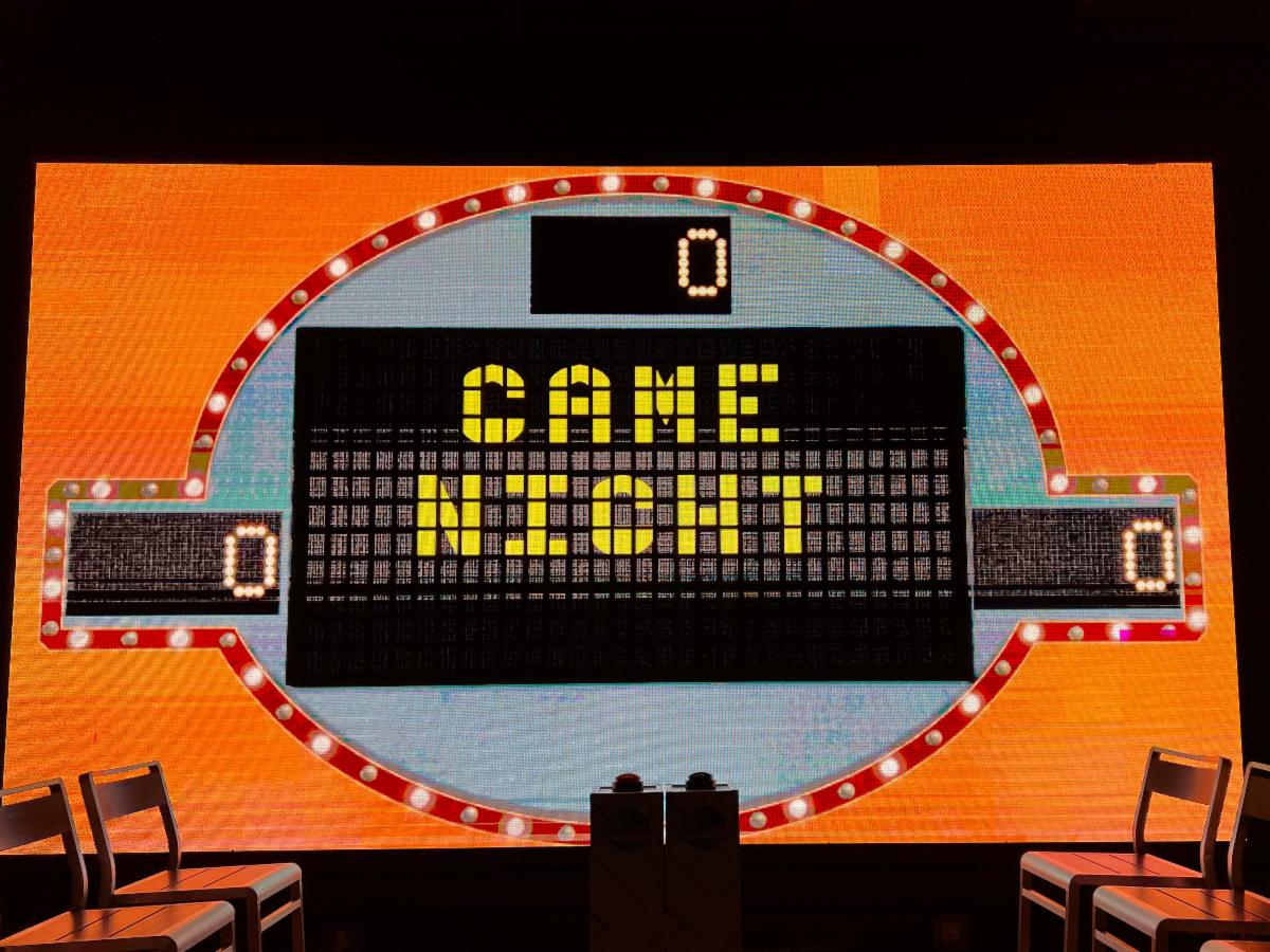 a large screen with a sign and lights