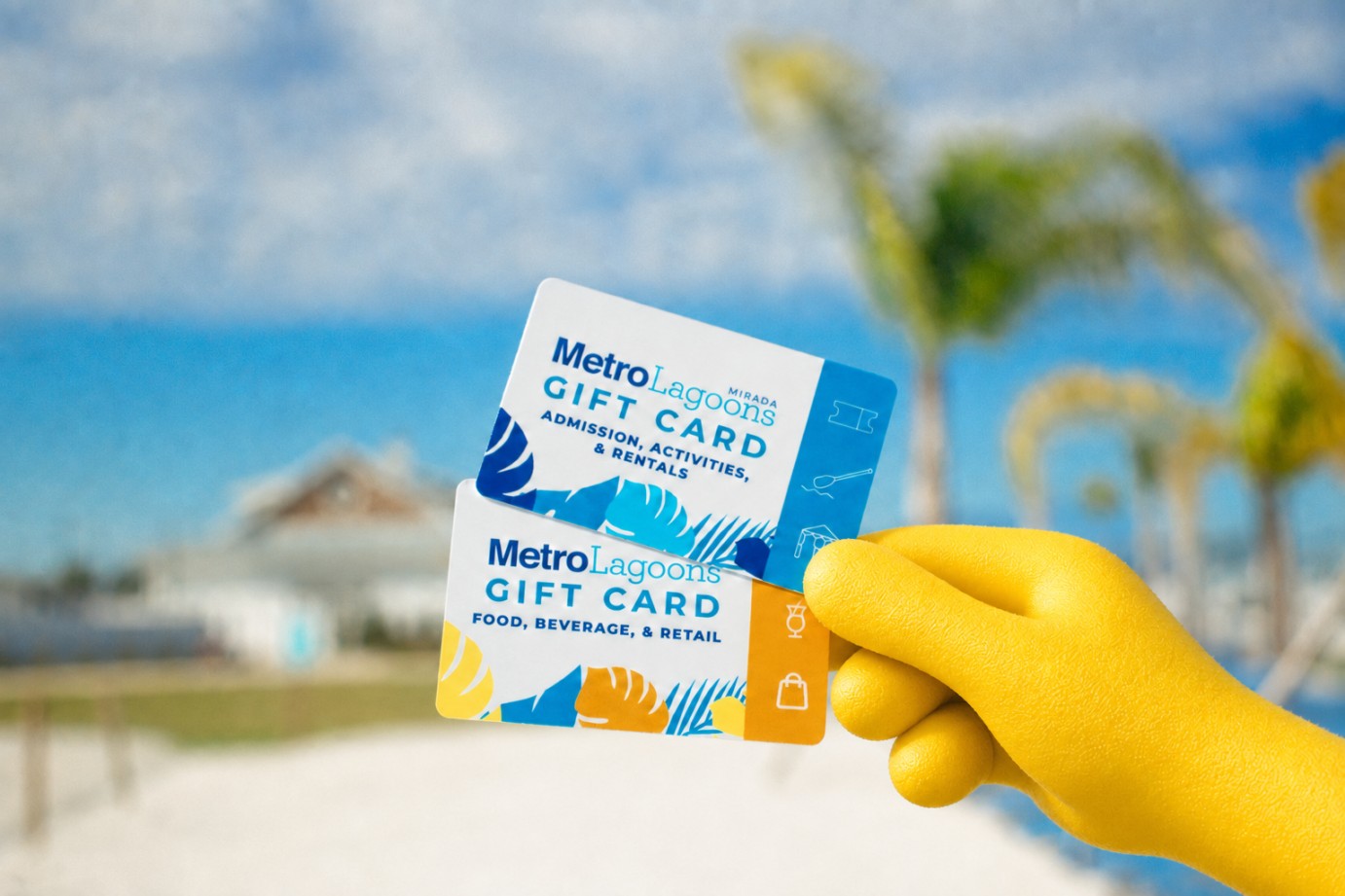 a hand in a yellow glove holding up two gift cards