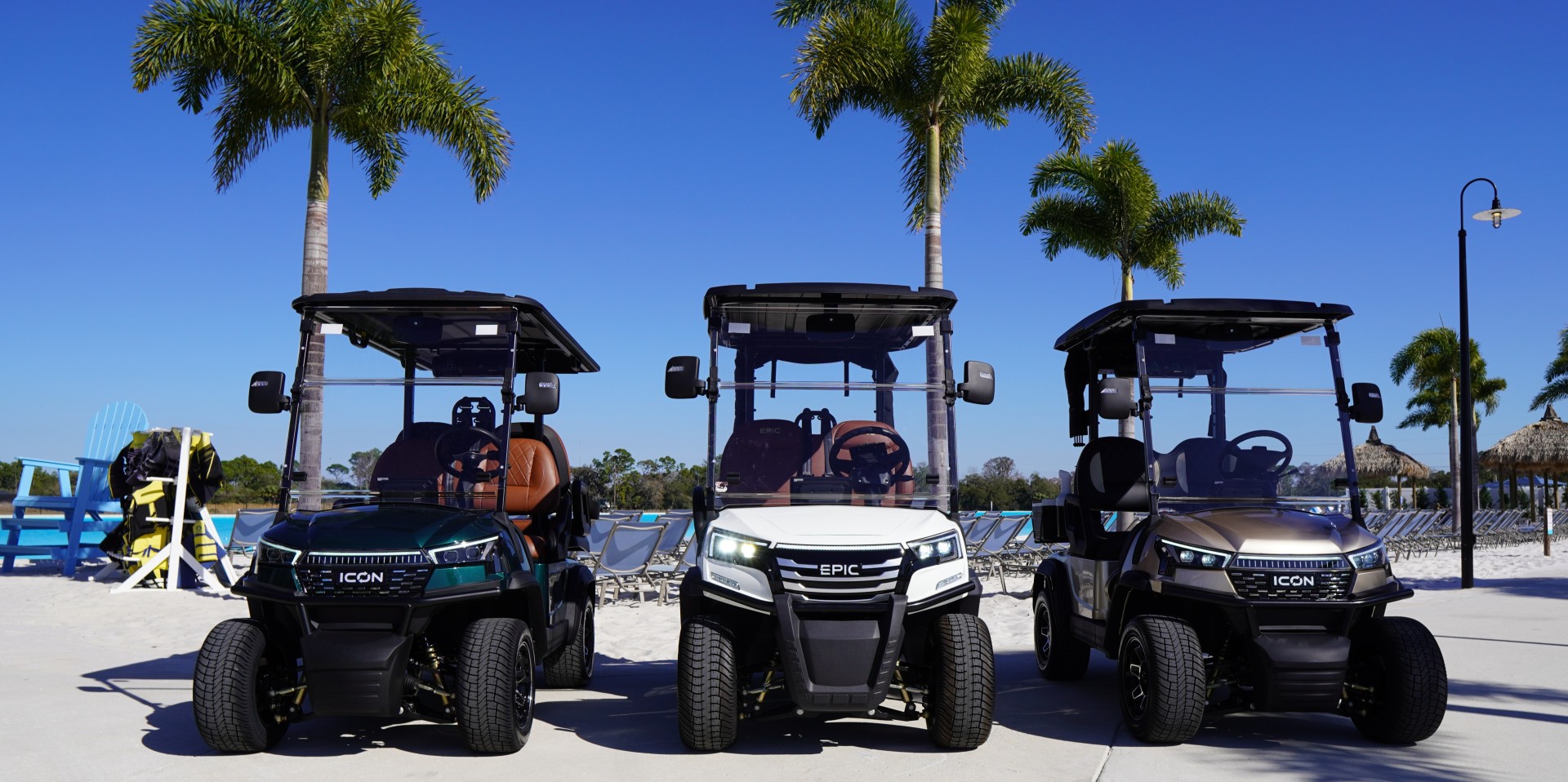 a group of golf carts parked on a beach