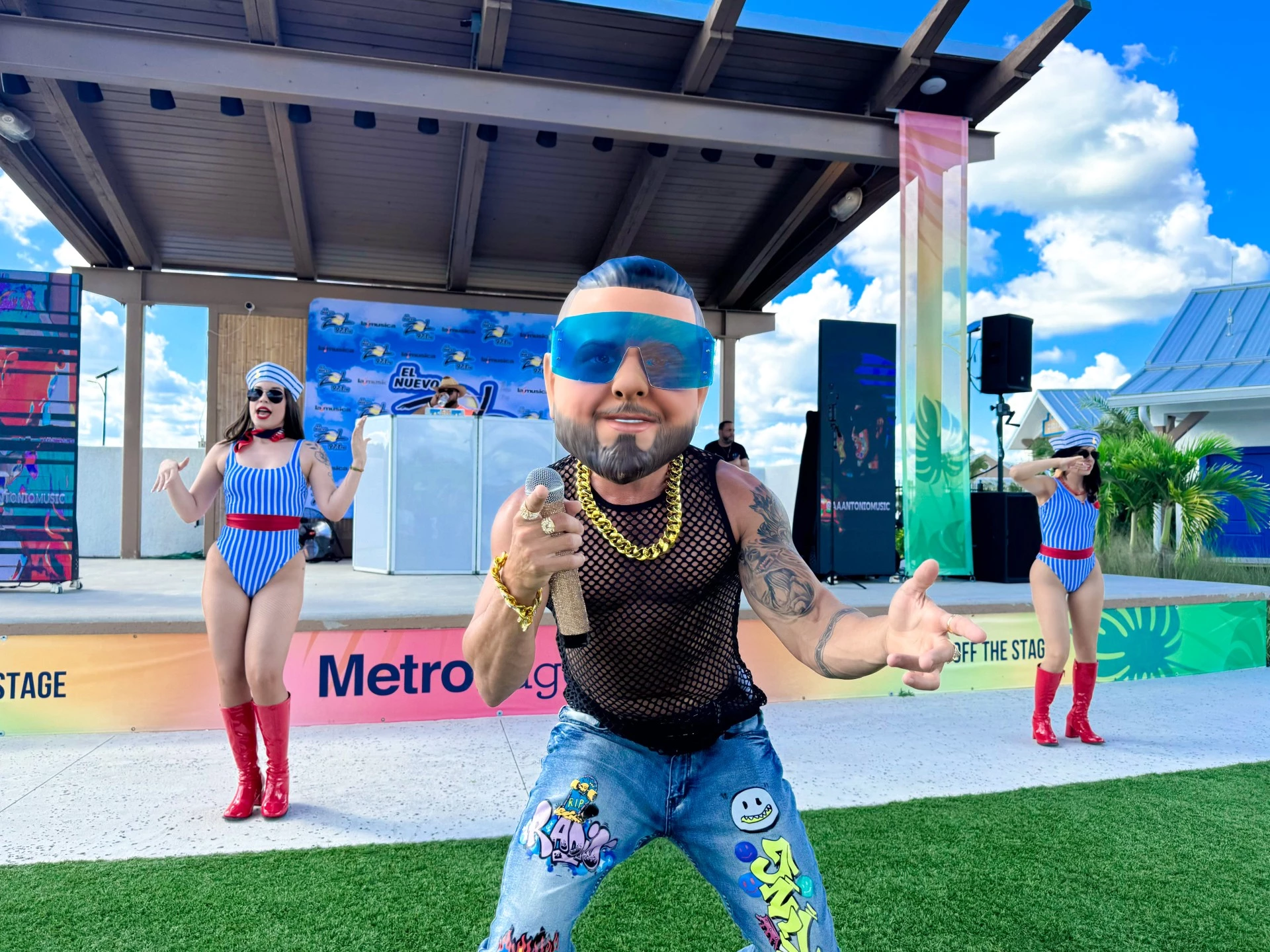 a man with a beard and sunglasses holding a microphone