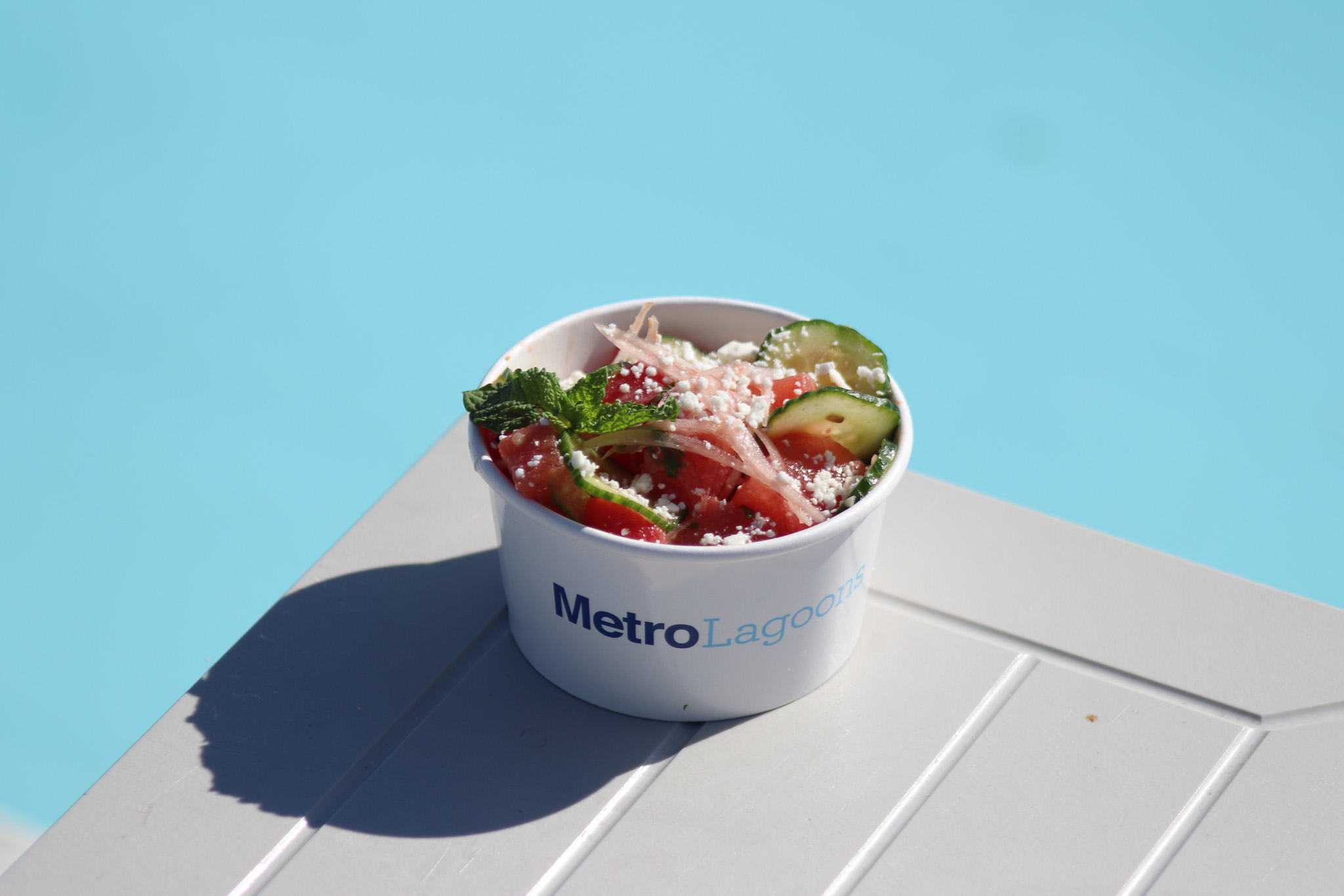 a bowl of salad with cheese and vegetables