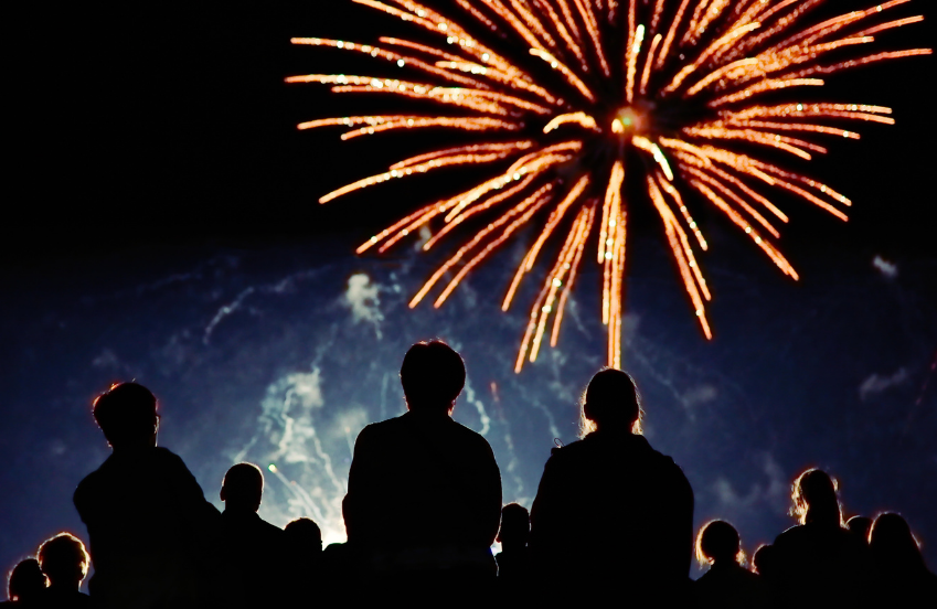 a group of people looking at fireworks