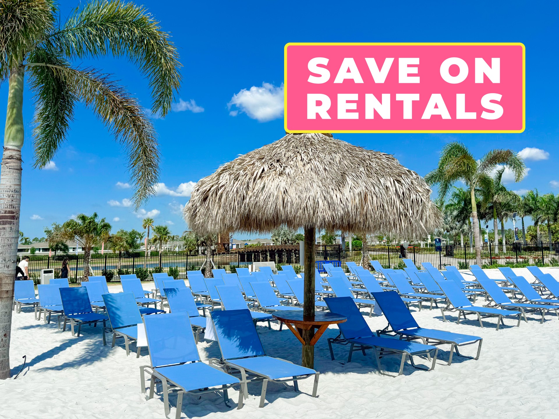 a group of blue chairs and a straw umbrella on a beach