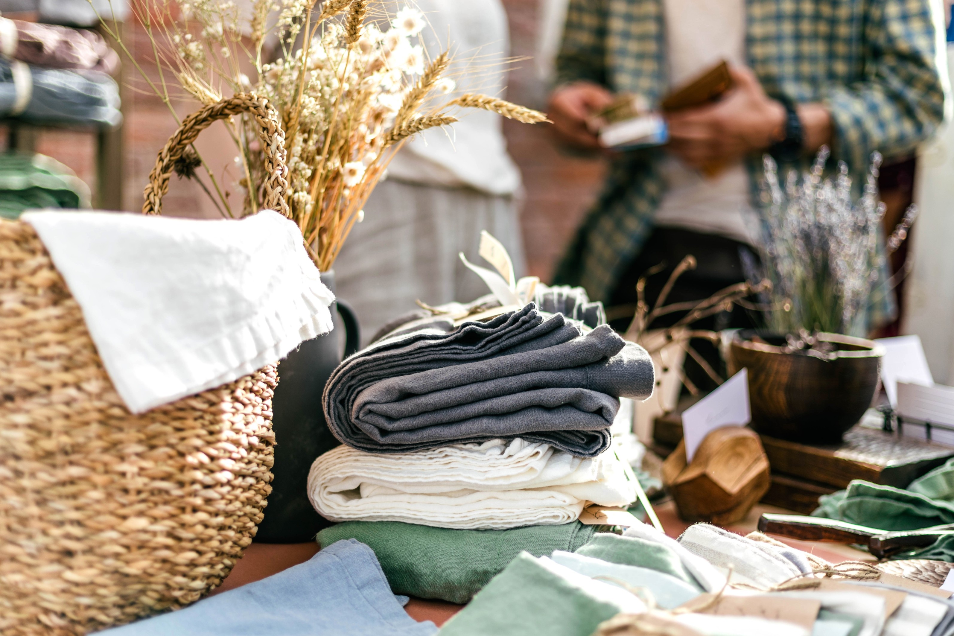 a stack of folded blankets and flowers