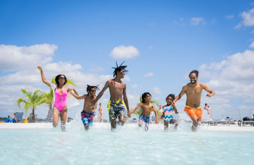 a group of people running in water