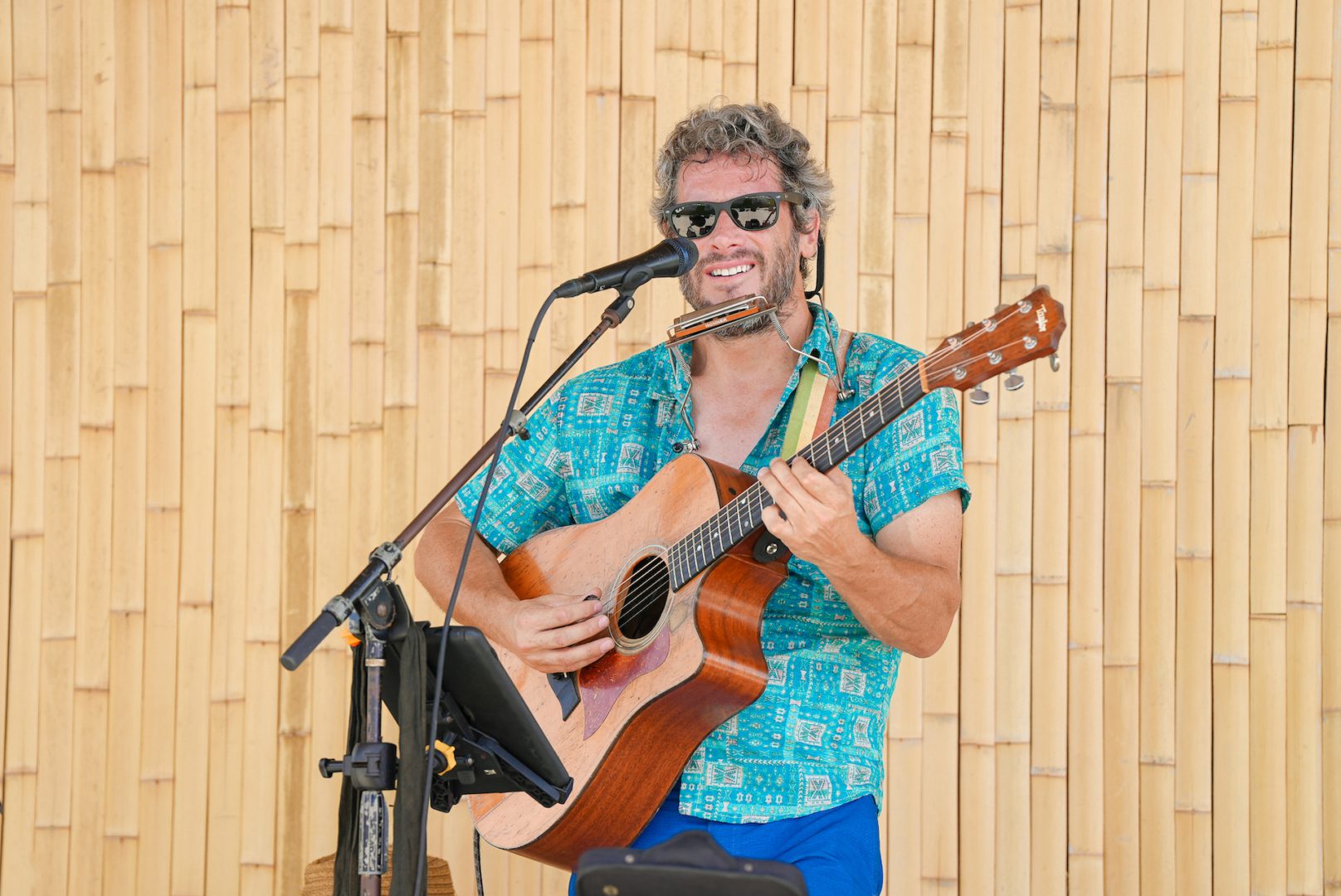 a man playing guitar and singing