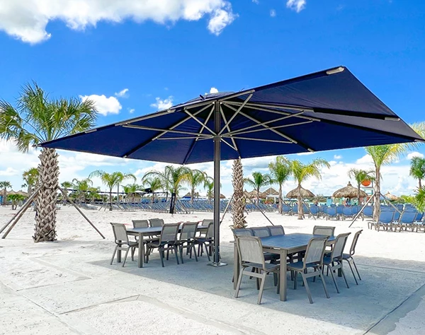 a table and chairs under a umbrella on a beach