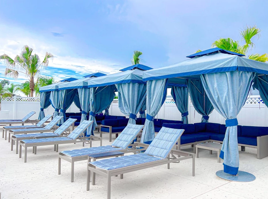 a group of blue chairs and umbrellas on a patio