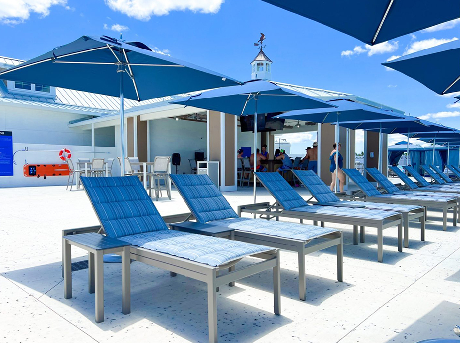 a group of chairs and umbrellas on a patio