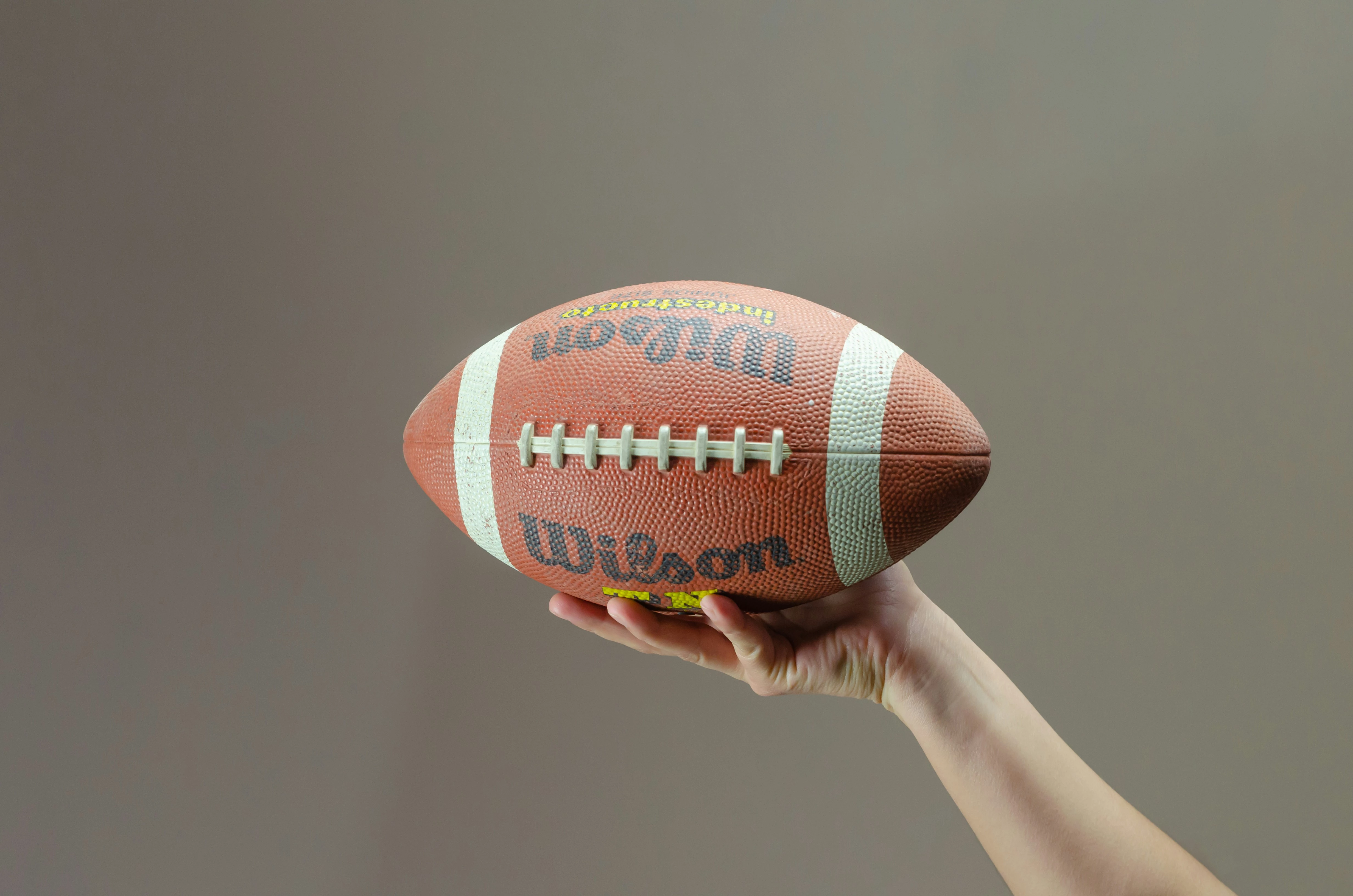 a hand holding a football