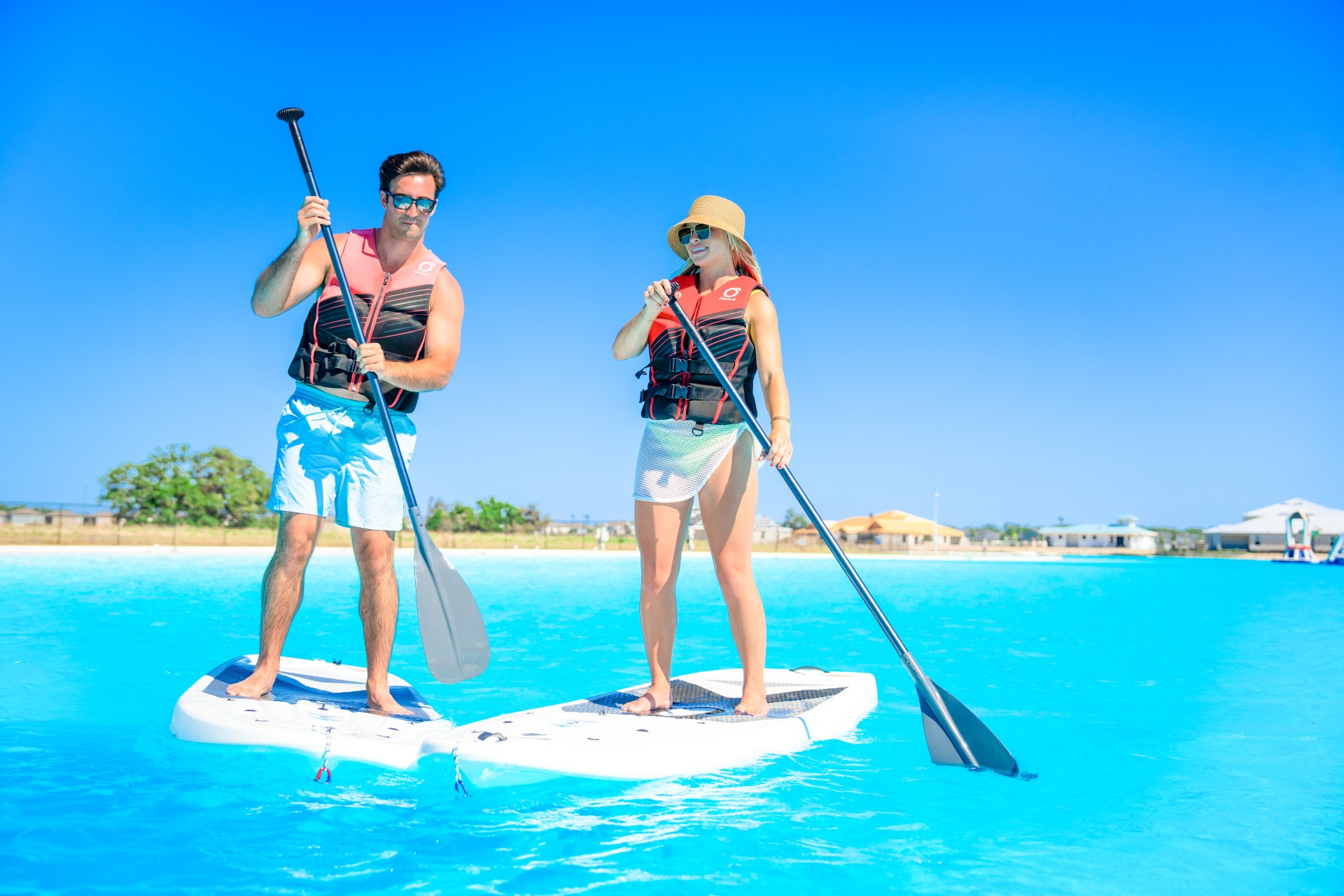 a man and woman on paddle boards in a body of water