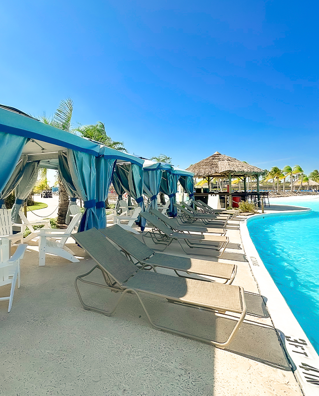 a pool with lounge chairs and umbrellas