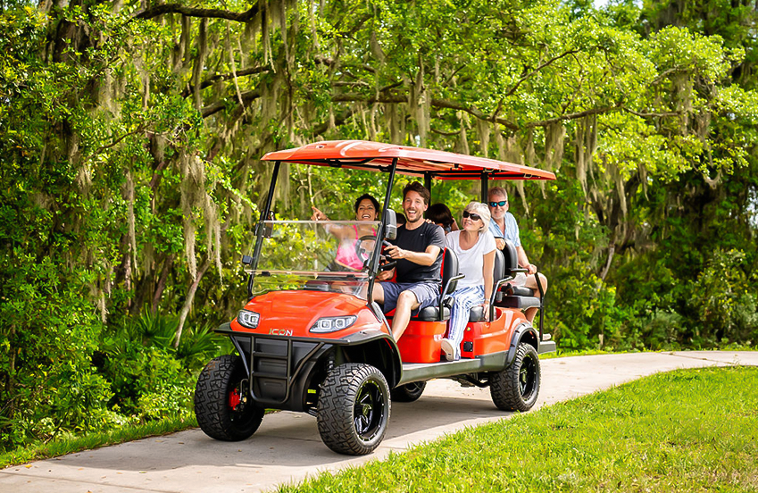 a group of people in a golf cart