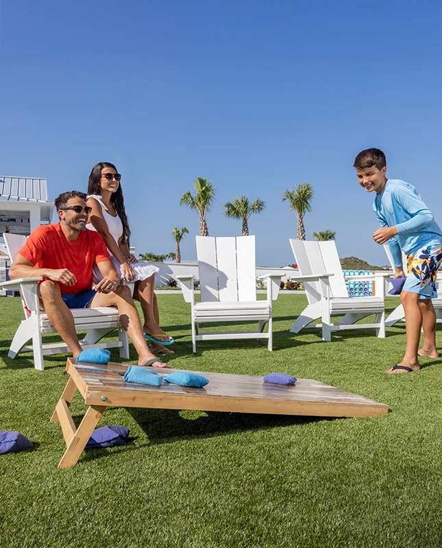a group of people sitting in chairs on grass