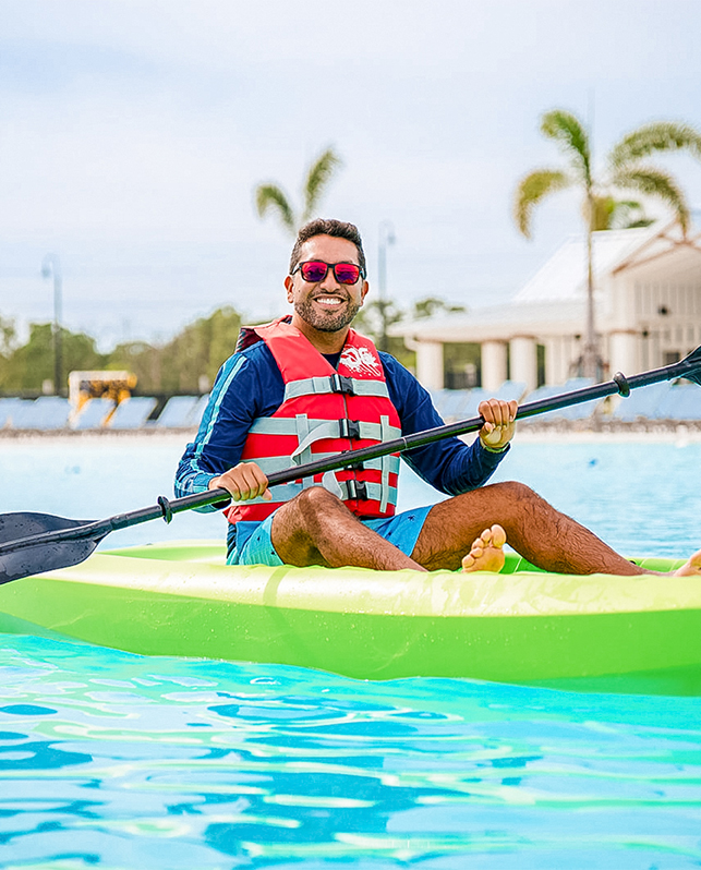 a man in a life jacket on a green kayak
