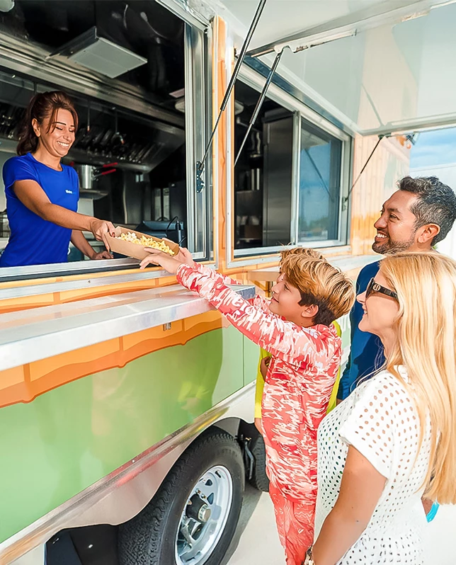 a group of people standing next to a food truck