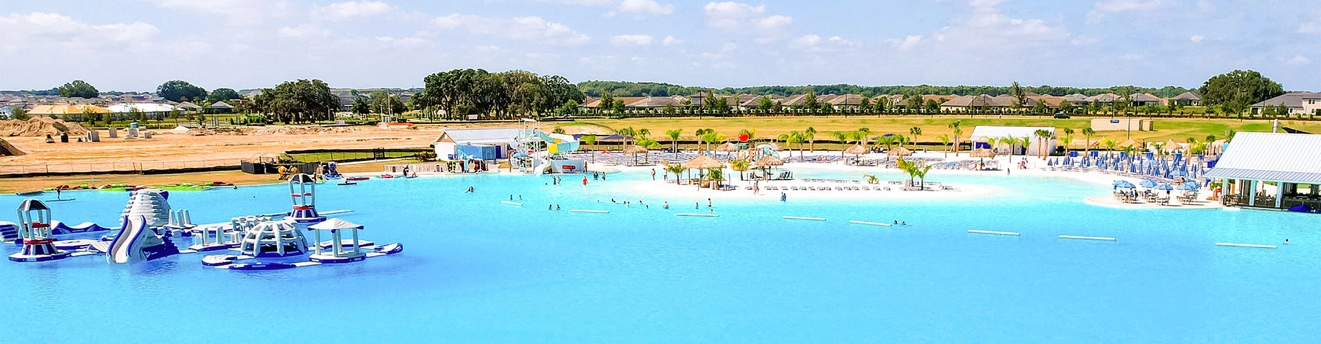 a water park with people swimming and a slide