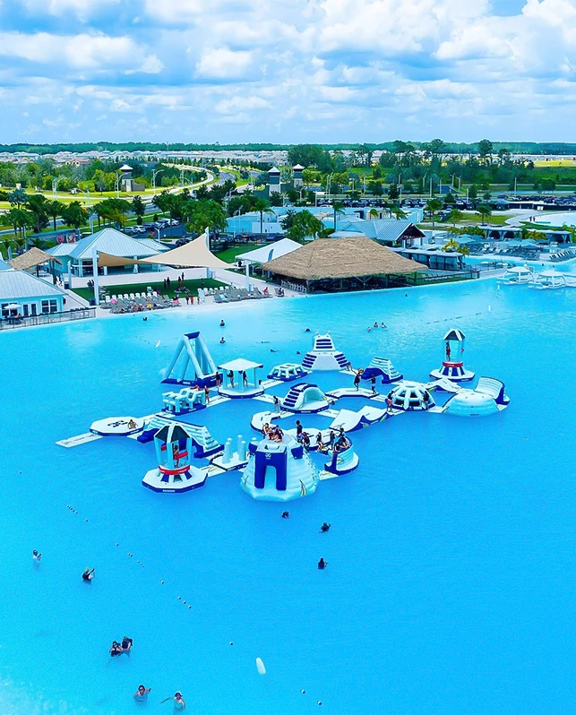 a water park with a large pool and people swimming