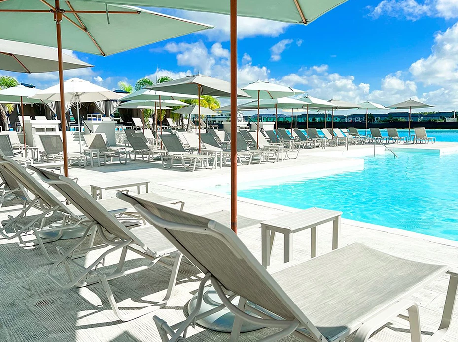 a pool with umbrellas and chairs