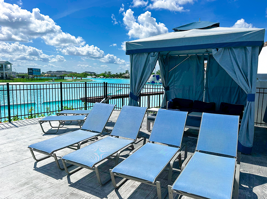 a group of blue chairs on a deck