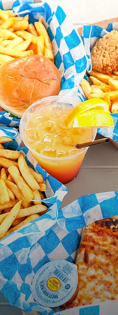a drink with a straw next to a plate of fries