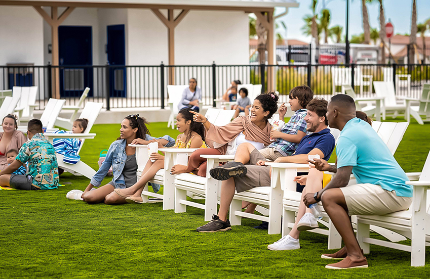 a group of people sitting on white benches