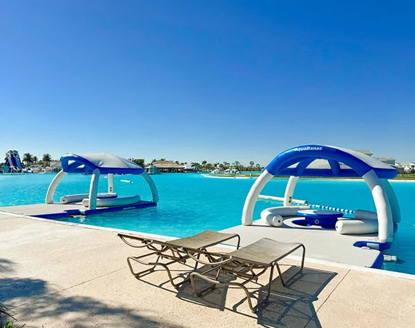 a pool with lounge chairs and rafts
