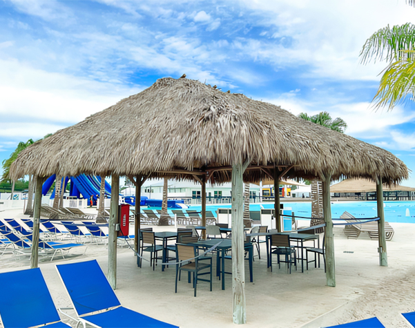 a hut with chairs and a pool