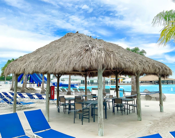 a hut with chairs and a pool