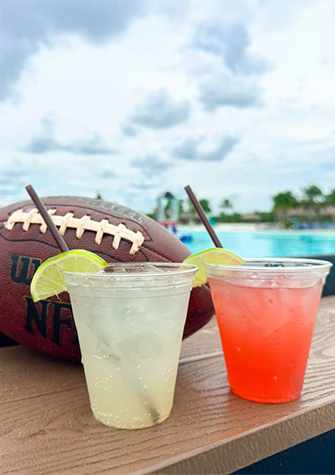 two drinks next to a football