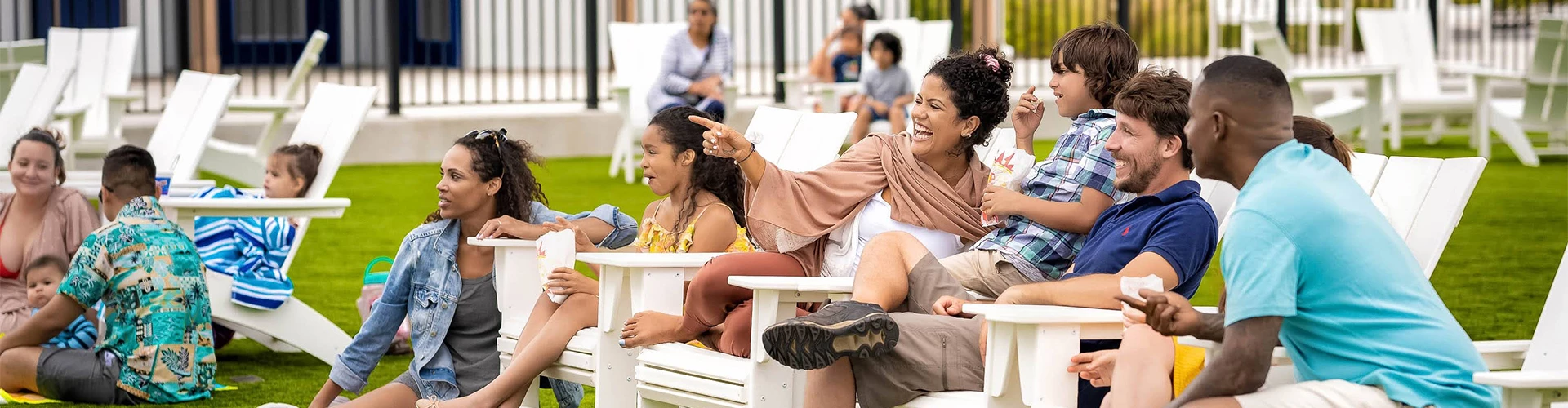 a woman laughing and pointing at something