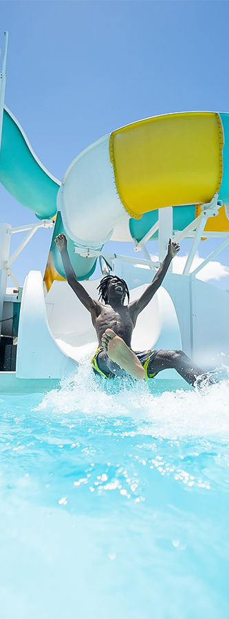 a man in a pool with his arms raised