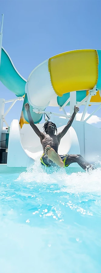 a man in a pool with his arms raised