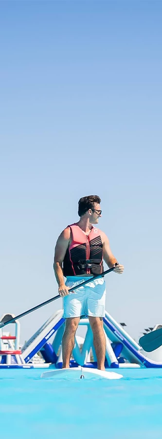 a man in a life jacket holding a paddle
