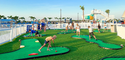 a group of kids playing mini golf