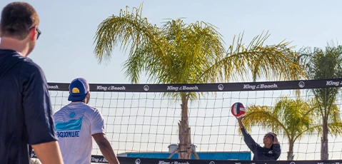 a couple of men playing volleyball