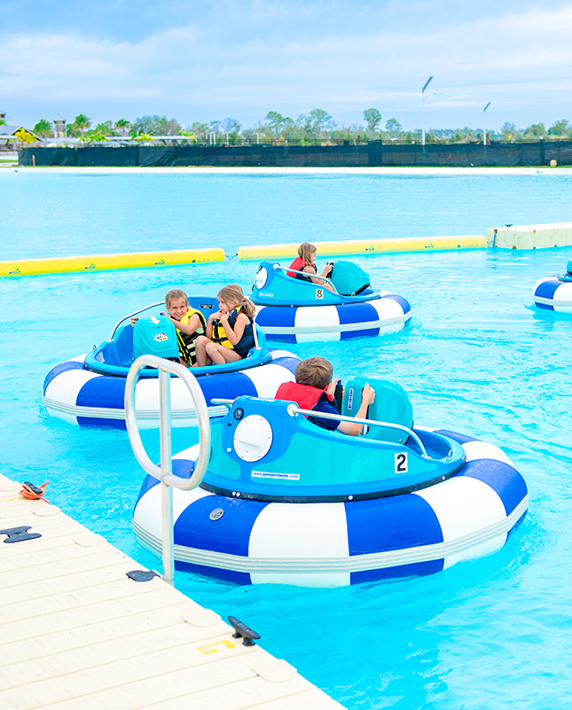 a group of kids on a bumper boat in a pool